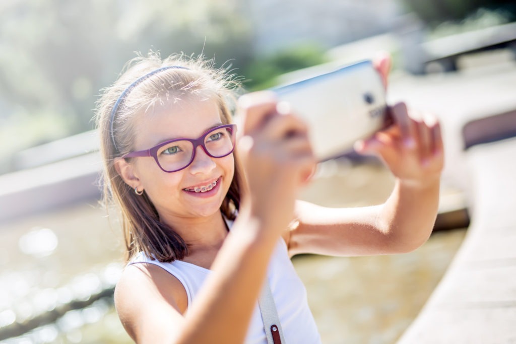 Young girl with braces taking selfie