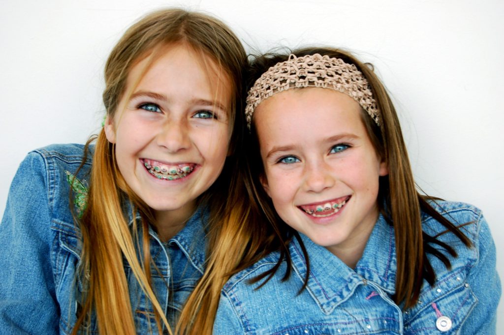 sisters smiling with braces