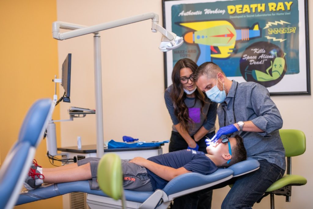 Dr. Matthew Dunn and an assistant treating a patient.